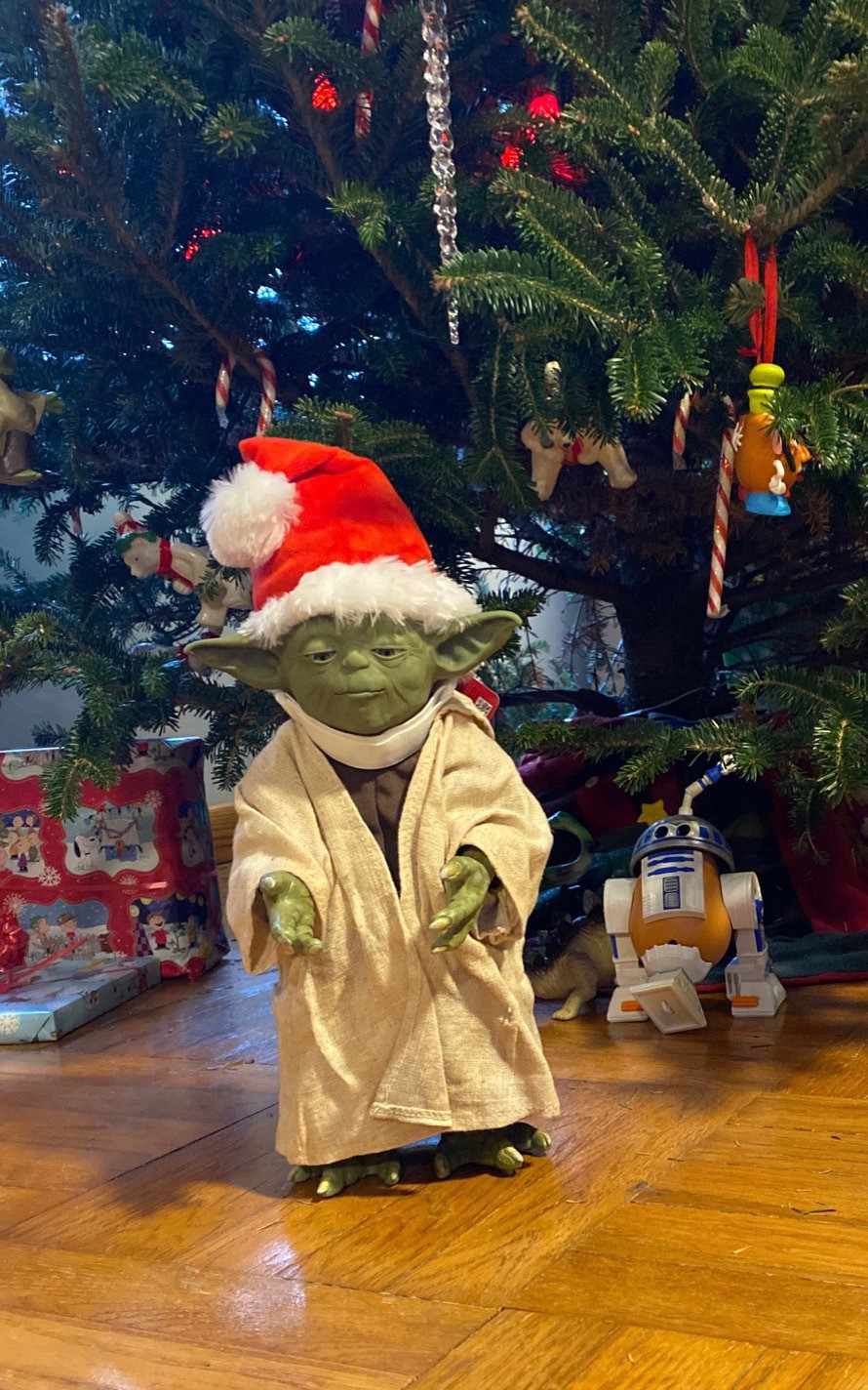 Life size Yoda wearing a Santa hat.